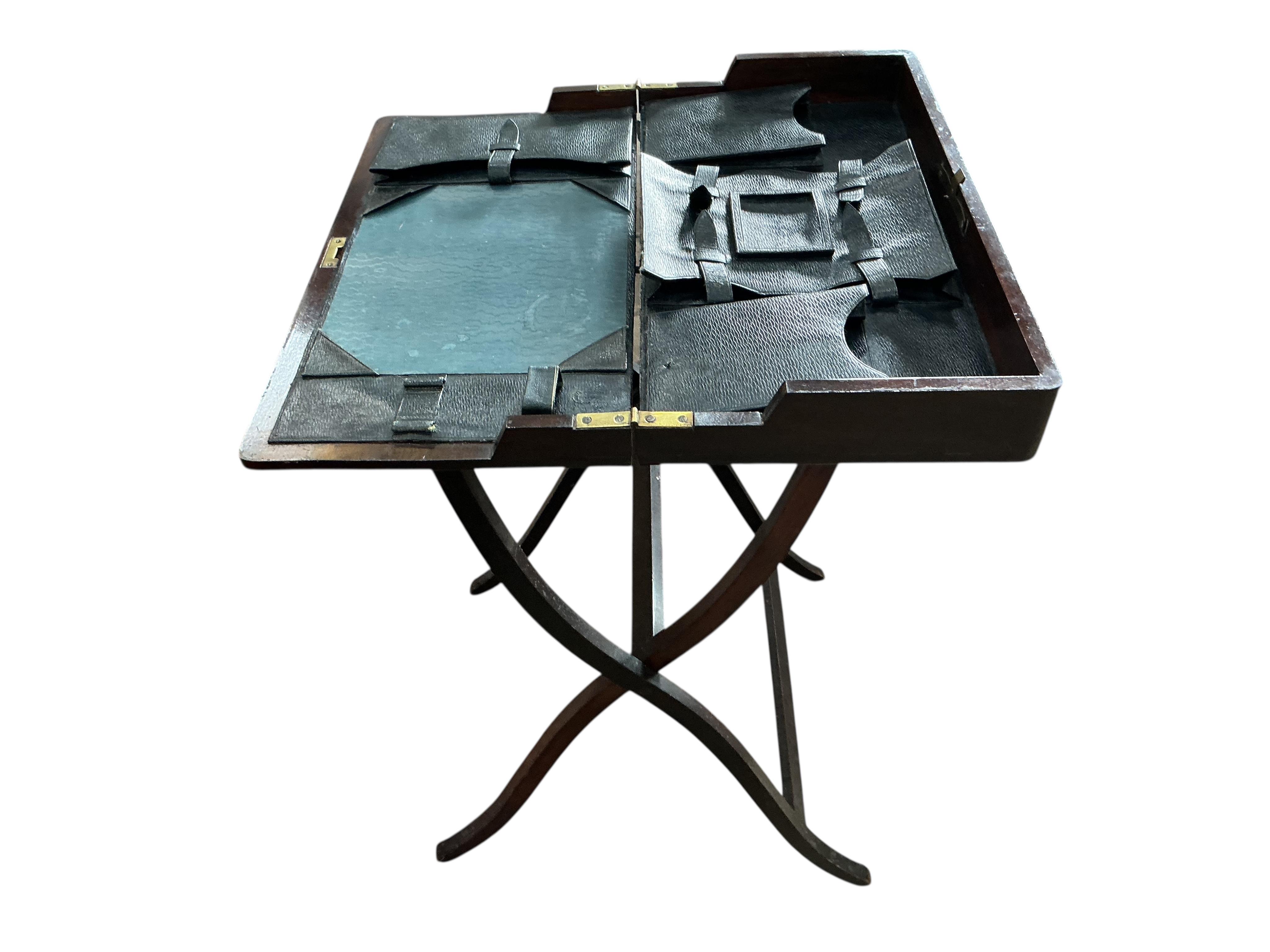 An early 20th century rectangular mahogany folding travelling writing table, width 56cm, height 92cm
